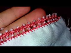 the beading is red and white with pearls on it