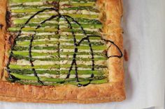 asparagus and cream cheese tart on top of a white tablecloth with black wire