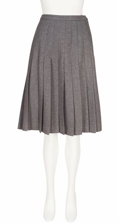 This early-1970s Valentino Boutique pleated knee-length skirt was made in Italy of unlined gray wool that fastens up the left side with a metal zipper. It's in excellent condition, professionally dry-cleaned and ready to wear. Measurements: Waist - 28" (pinned on the mannequin) Hips - 38" Length - 24" Label Size: 14 (fits like a S/M) IMPORTANT NOTE FOR CANADIAN SHOPPERS: There is a 15% shipping fee that is automatically applied to Canadian orders, as legally we need to charge and remit sales tax domestically. We will promptly refund any overcharge, and apologize for any inconvenience. Pleated Skirt Knee Length, Classic Knee-length Pleated Skirt For Fall, Pleated Wool Skirt For Fall, Fall Classic Knee-length Pleated Skirt, Classic Knee-length Pleated Skirt For Winter, Classic Fitted Gray Pleated Skirt, Evening Knee-length Accordion Pleated Skirt, Classic Gray Fitted Pleated Skirt, Formal Gray Knee-length Skirt