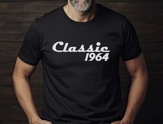 a man wearing a black classic t - shirt with the word classic in white on it