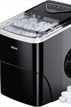 an image of a small ice maker with lots of ice cubes on it's side