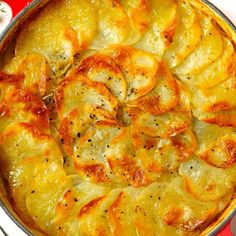 a casserole dish with potatoes in it on a red and white tablecloth