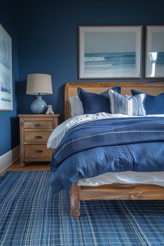 a bedroom with blue walls and carpeted flooring, two framed pictures on the wall