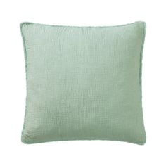 a light green pillow on a white background