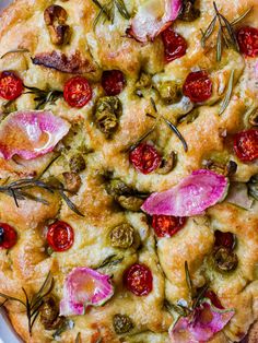 a pizza topped with tomatoes and other toppings