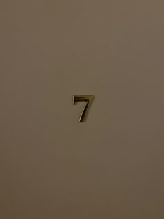 the number seven is shown in gold on a white background