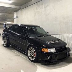 a black car parked in a parking garage