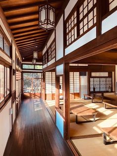 an empty room with wooden floors and windows in the center is lit by sunlight streaming through the window panes