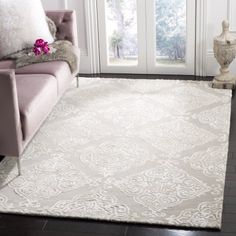 a living room with a pink couch and white rug