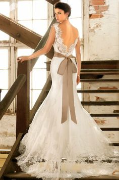 a woman in a wedding dress standing on stairs