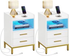 two white nightstands with gold handles and lamps on each side, one has a phone hooked up to it