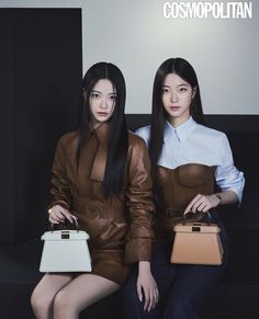 two women sitting next to each other holding purses