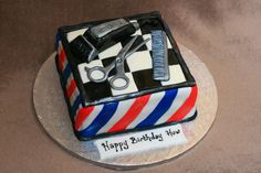 a birthday cake for a barbershop with scissors, combs and a hair dryer