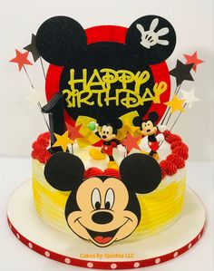 a birthday cake with mickey mouse on top