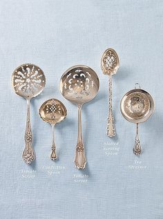 an assortment of antique silverware including spoons, forks and spoons with names on them