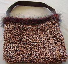 a purse made out of bird seed and leather straps on a white tablecloth background