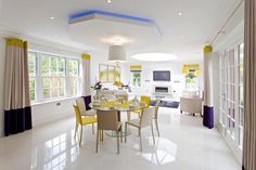 a dining room with yellow chairs and white tile flooring is pictured in this image