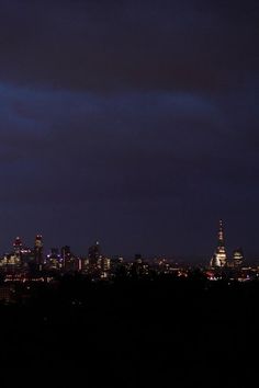 the city skyline is lit up at night