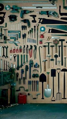 there are many tools hanging on the wall