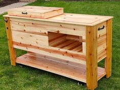 a large wooden box on wheels in the grass