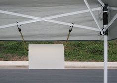 an empty white box under a canopy on the street