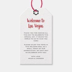 a welcome to las vegas gift tag with a red string hanging from the front and back