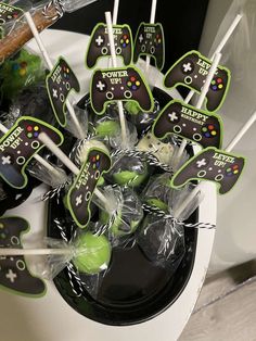 a bowl filled with green and black cupcakes