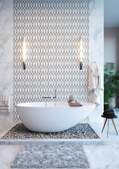 a white bath tub sitting on top of a bathroom floor next to a wall mounted mirror