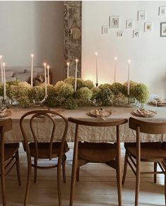 a dining room table with candles and flowers on it