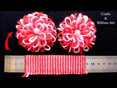 two red and white yarn flowers next to a measuring tape on a black background with text that reads crafts & ribbon art