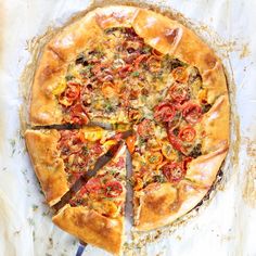 a pizza sitting on top of a pan covered in toppings