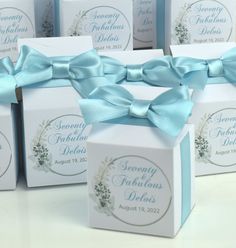 several small boxes with blue bows on them are shown in this image, and the box is labeled seventy fabulous designs