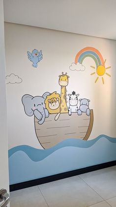 an elephant and giraffe mural on the side of a wall in a children's room