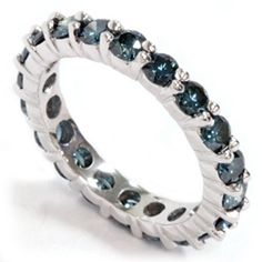 a white gold ring with blue diamonds