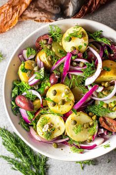 a white bowl filled with vegetables on top of a table