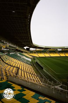 an empty soccer stadium filled with yellow and green seats