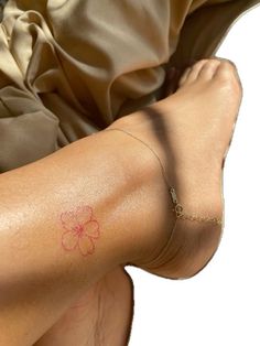 a person with a flower tattoo on their left arm and the other half of her leg