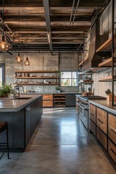 an industrial style kitchen with lots of counter space and hanging lights over the island area