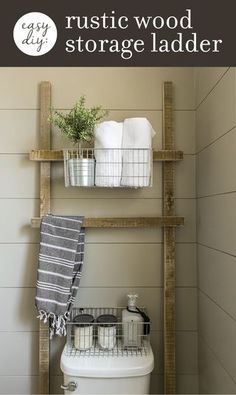 a white toilet sitting next to a wooden shelf filled with towels and other bathroom items