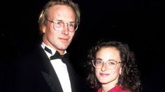 a man in a tuxedo standing next to a woman