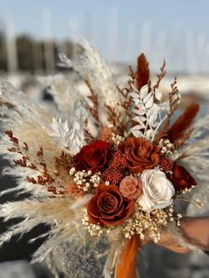 a bridal bouquet with feathers and flowers