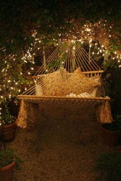 a hammock is lit up with fairy lights