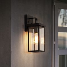 an outdoor wall light with two lights on it's side and the door open