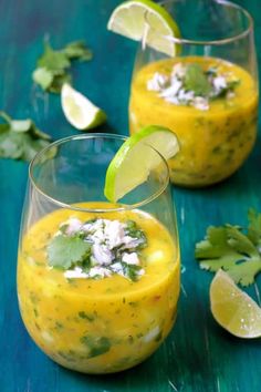 two glasses filled with food and garnished with cilantro