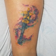 a person with a tattoo on their leg that has an image of a cartoon character holding a hammer