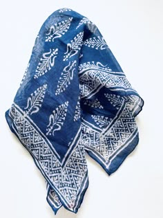 a blue and white bandana laying on top of a table