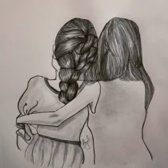 two girls hugging each other with their arms around one another, drawing by hand on paper