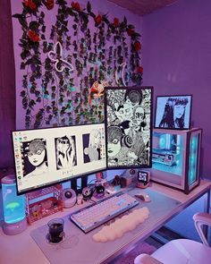 two computer monitors sitting on top of a desk next to each other in front of a purple wall