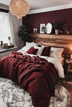 a bedroom with red walls and white fur rugs on the floor next to a bed