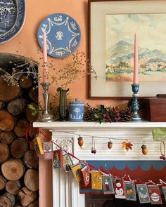 a fireplace with christmas decorations and candles on it